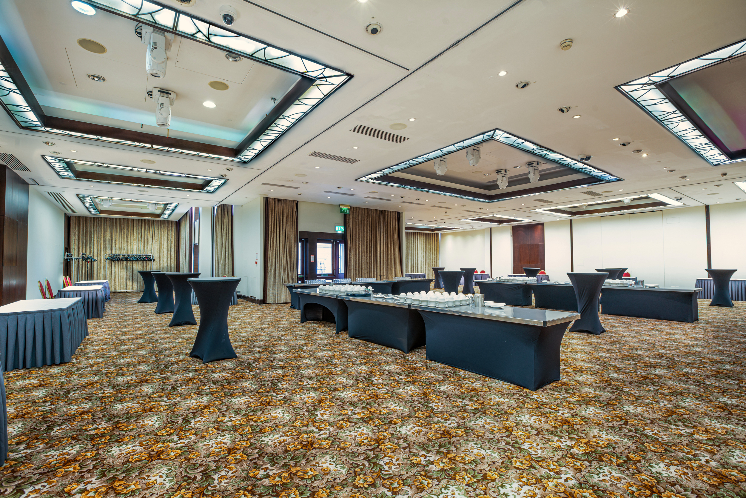 Spacious event space with high-top tables for meetings and conferences in London.