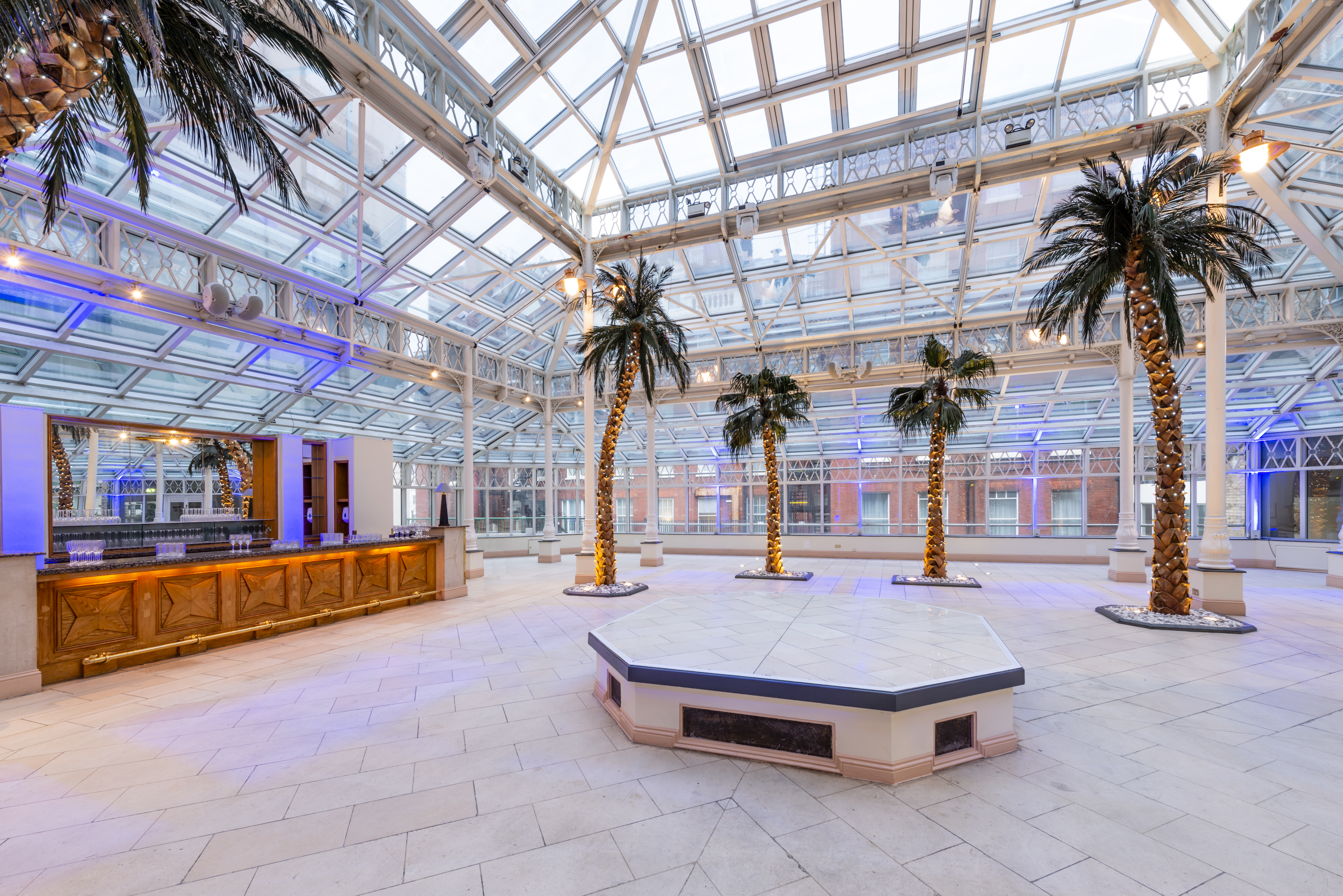 Spacious event venue with glass ceiling, ideal for conventions and receptions in London.