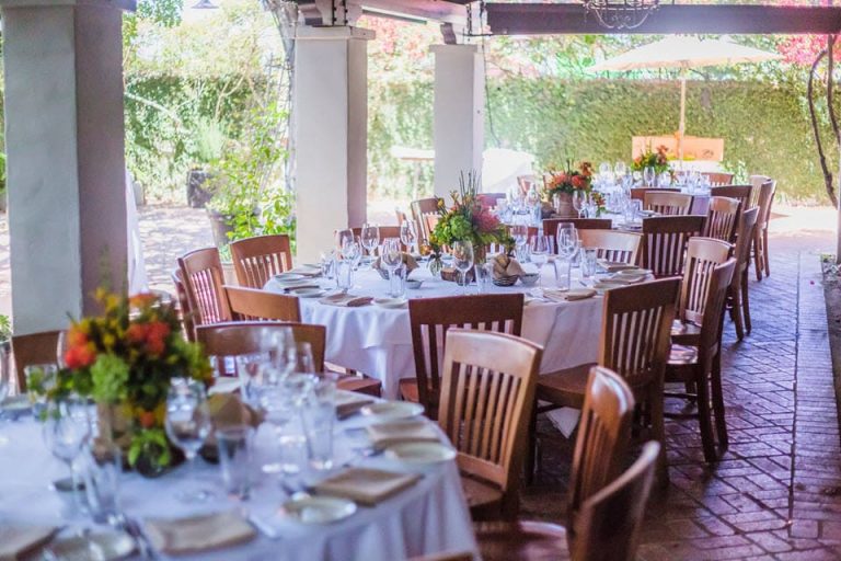 Elegant outdoor banquet facilities with round tables, ideal for weddings and events.