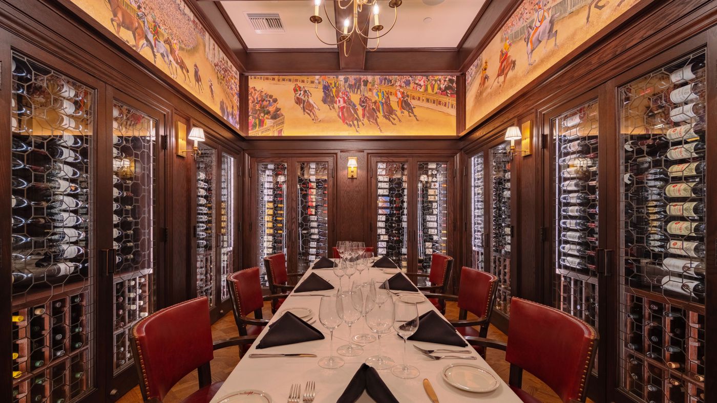 Elegant private dining room with rich wood paneling for corporate meetings and wine tastings.