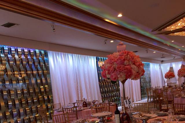 Elegant reception hall with floral centerpieces, ideal for weddings and upscale events.