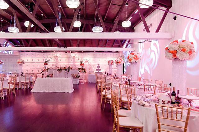 Elegant reception hall with floral centerpieces, ideal for weddings and upscale events.