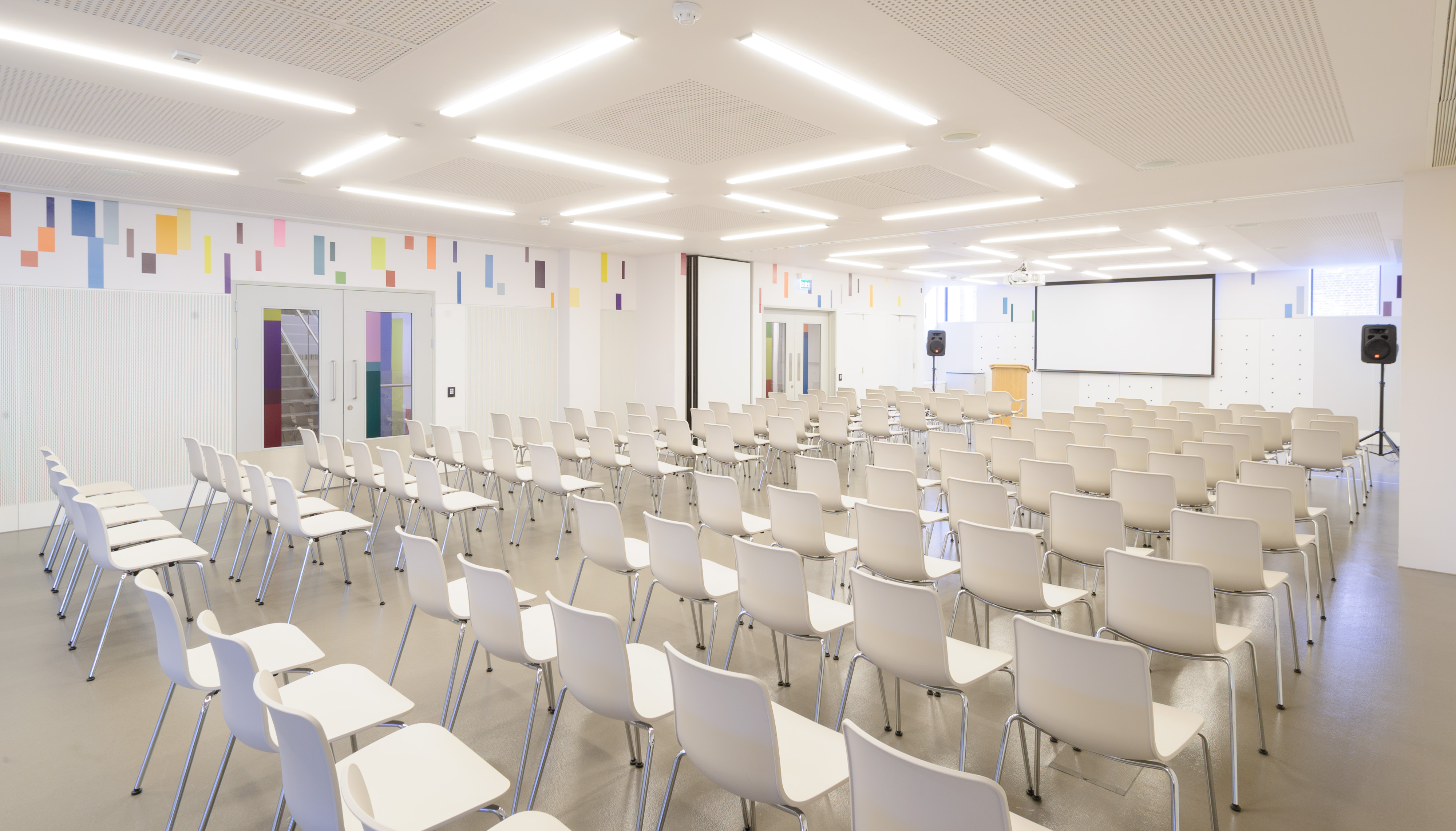 Foyle Centre event space with white chairs, ideal for seminars and presentations.