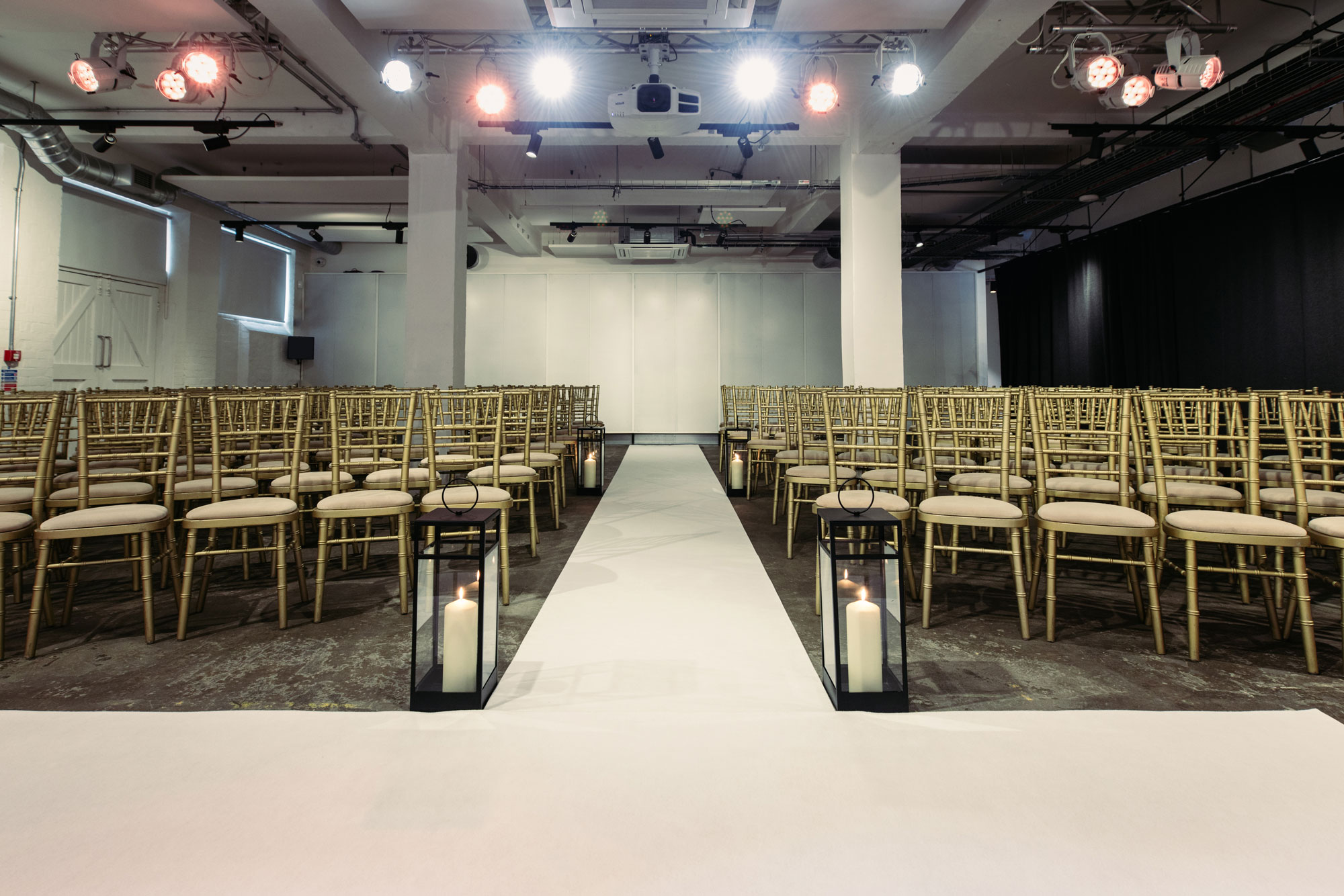 Elegant event space with gold chiavari chairs for weddings and corporate events.