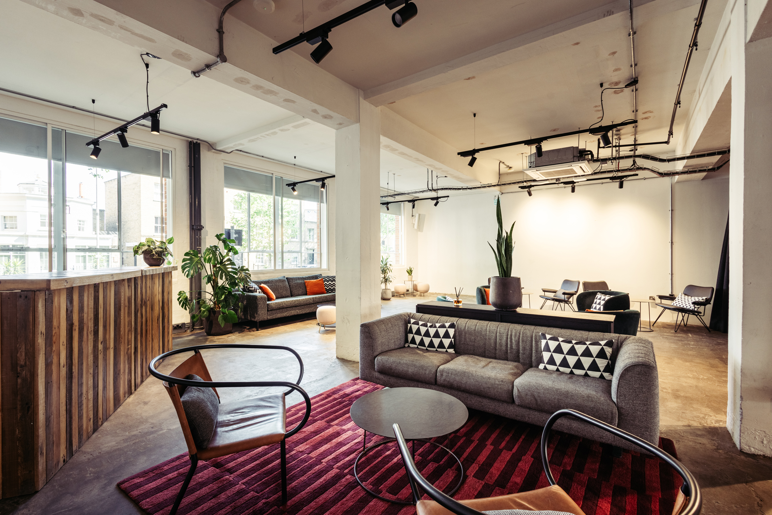 Modern event space with natural light and stylish furnishings for meetings and networking.