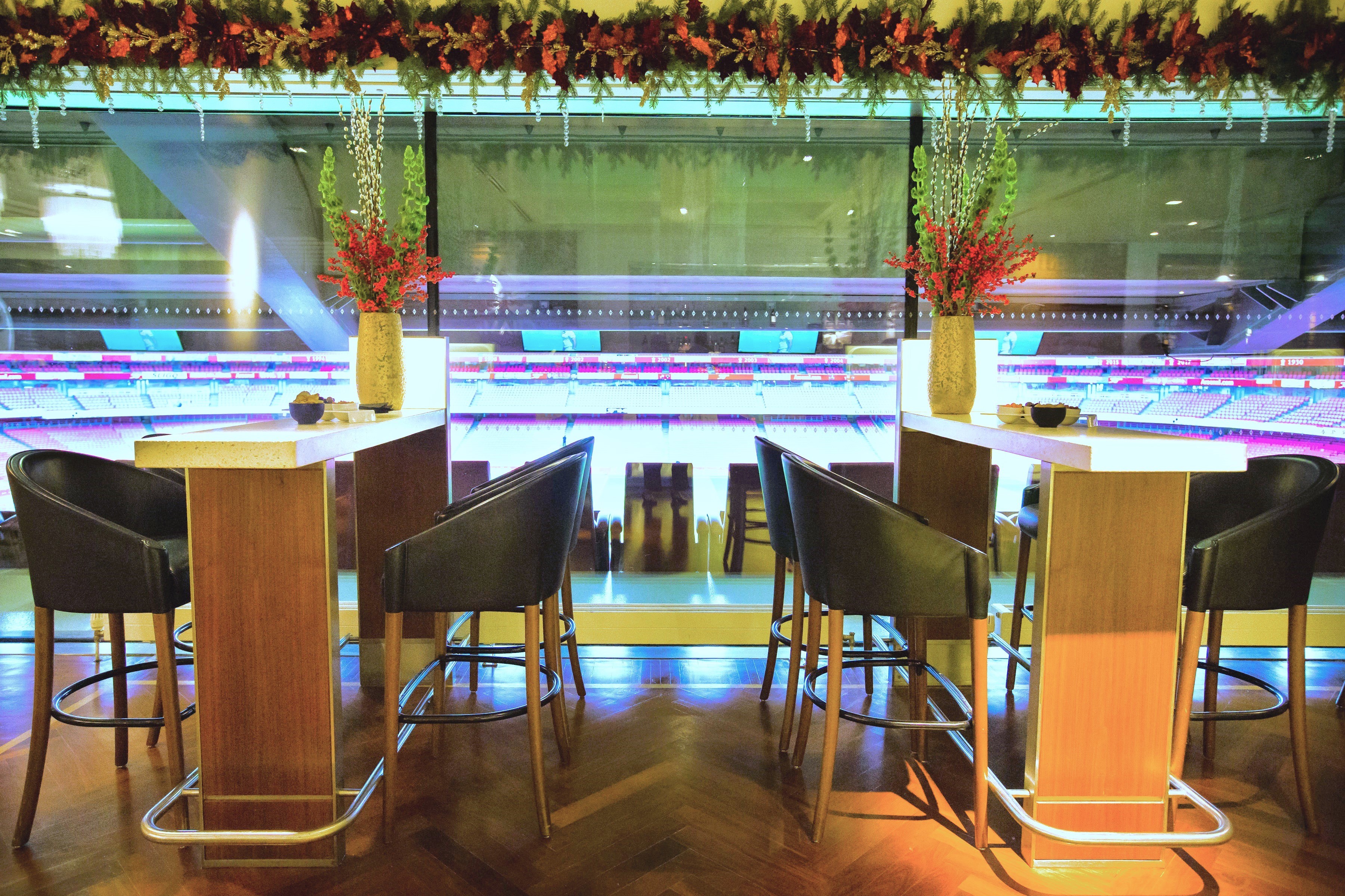 "Christmas event at Emirates Stadium with elegant floral arrangements and networking space."