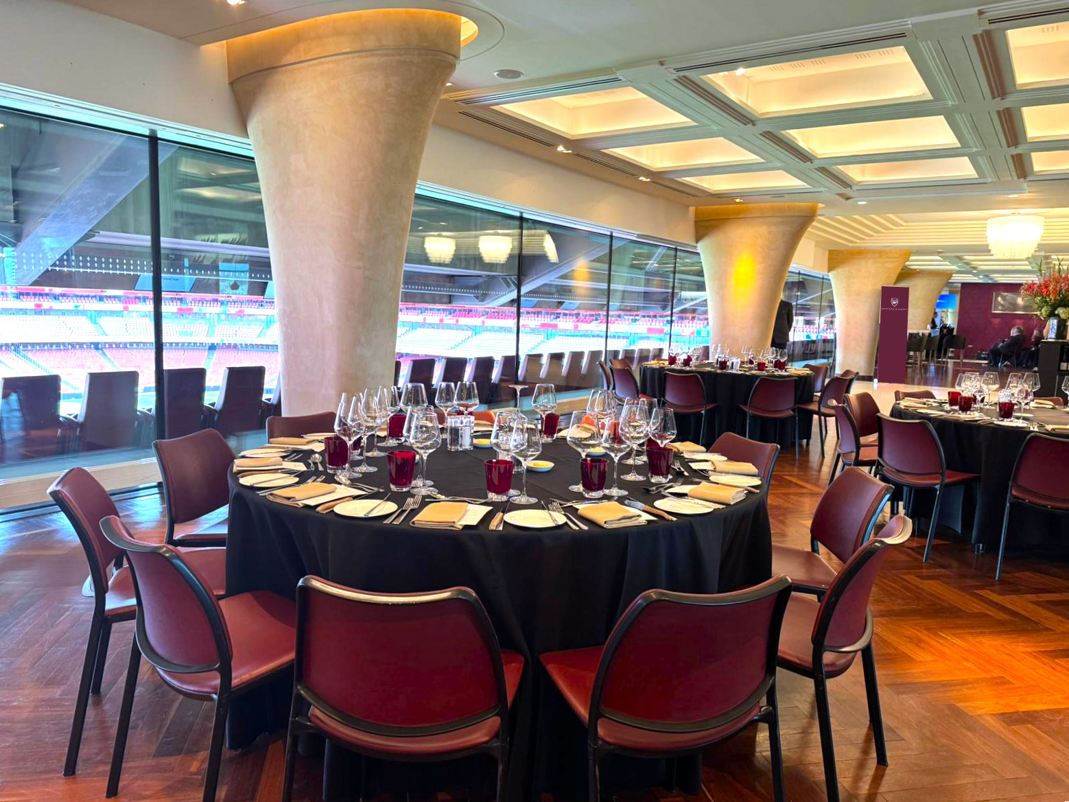 Christmas dinner setup at Emirates Stadium with elegant tables for corporate events.
