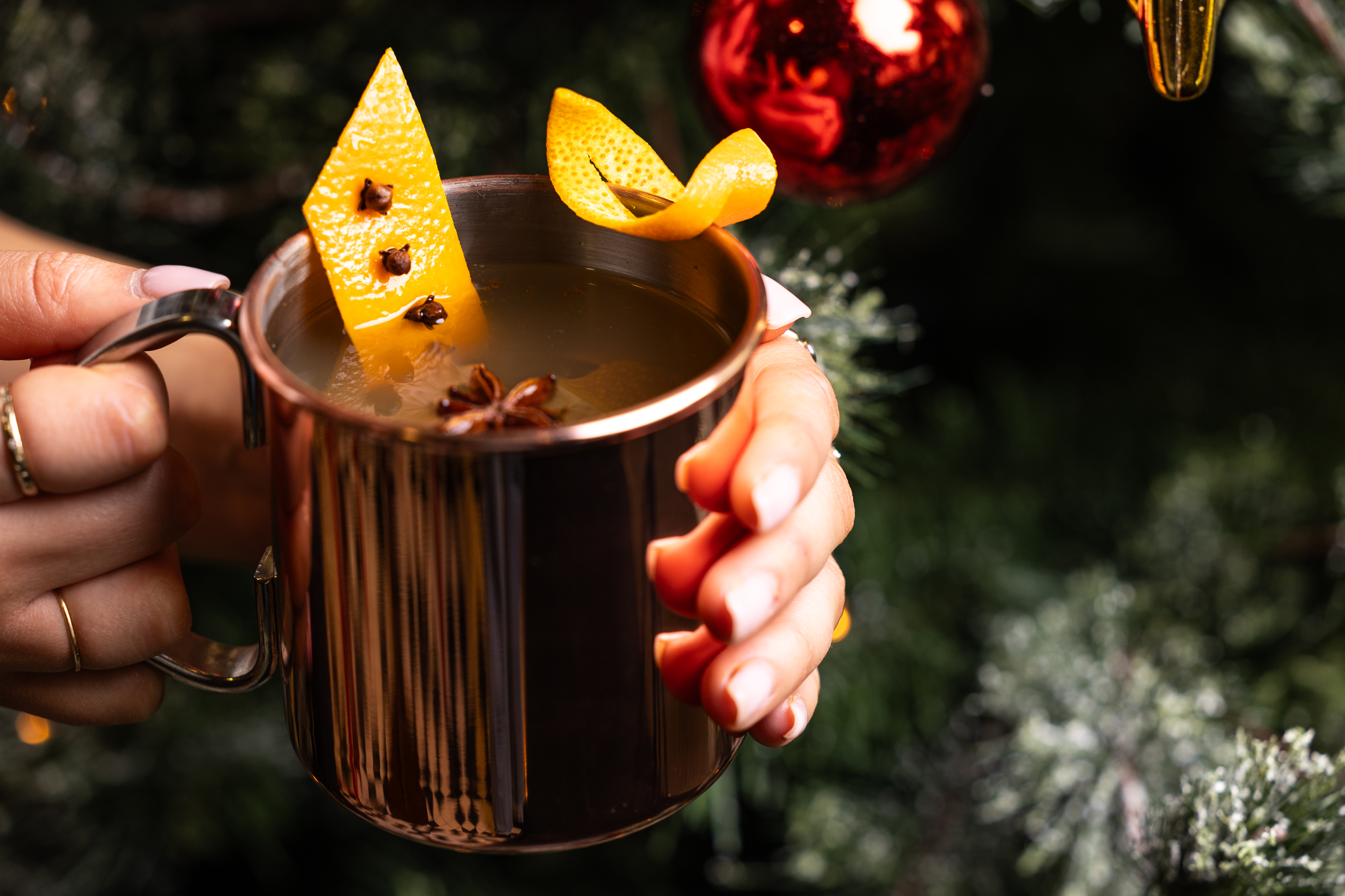 Holiday cocktail with orange peels at Arsenal's Emirates Stadium Christmas event.