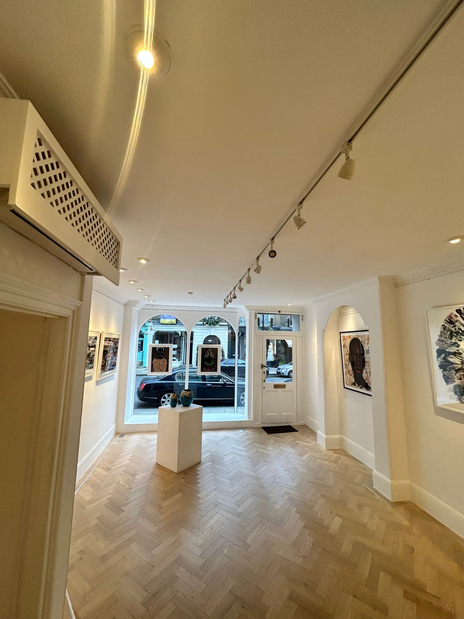 Bright modern gallery space with large windows for art exhibitions and intimate events.