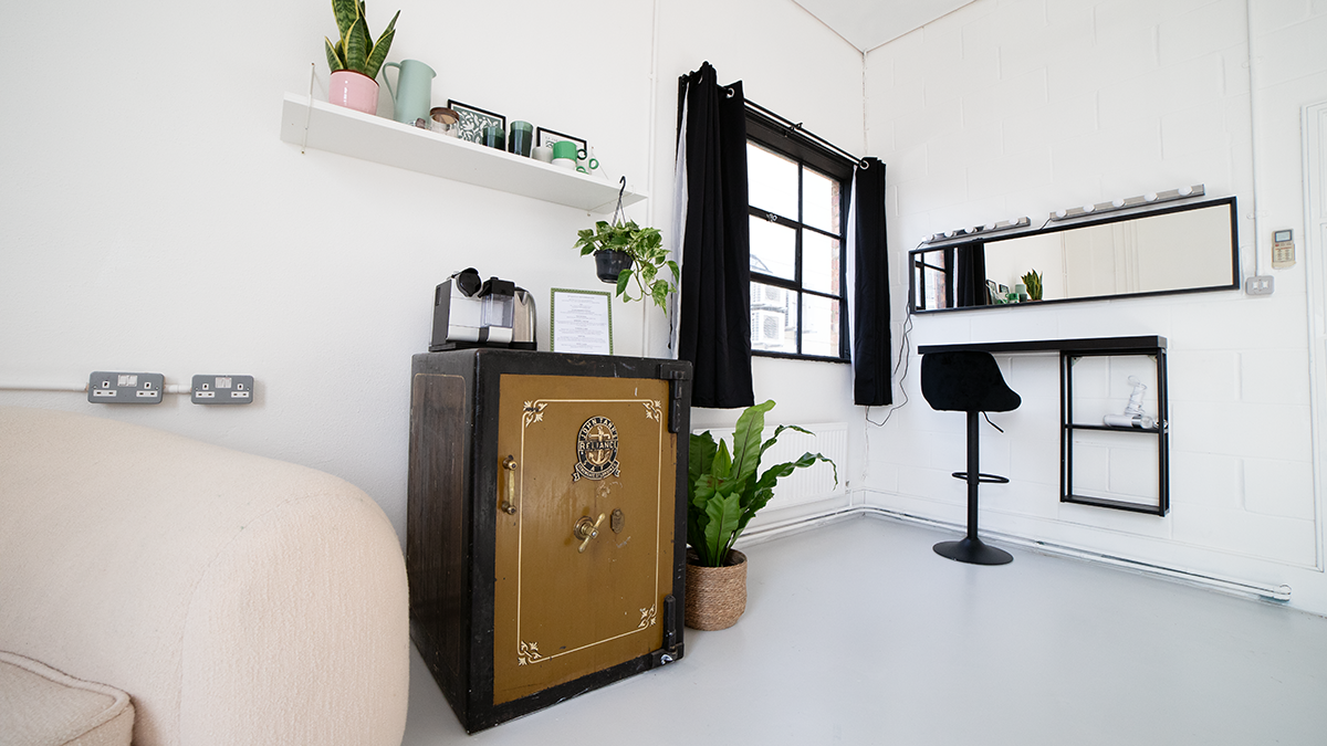 Bijou Room at Klatch Studio: minimalist meeting space with gold safe, ideal for gatherings.