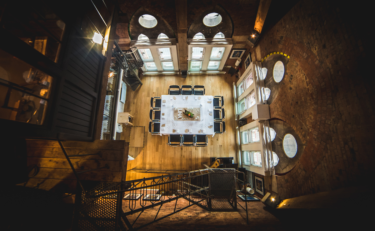 Stylish meeting space at UNA King's Cross with circular windows and modern decor.