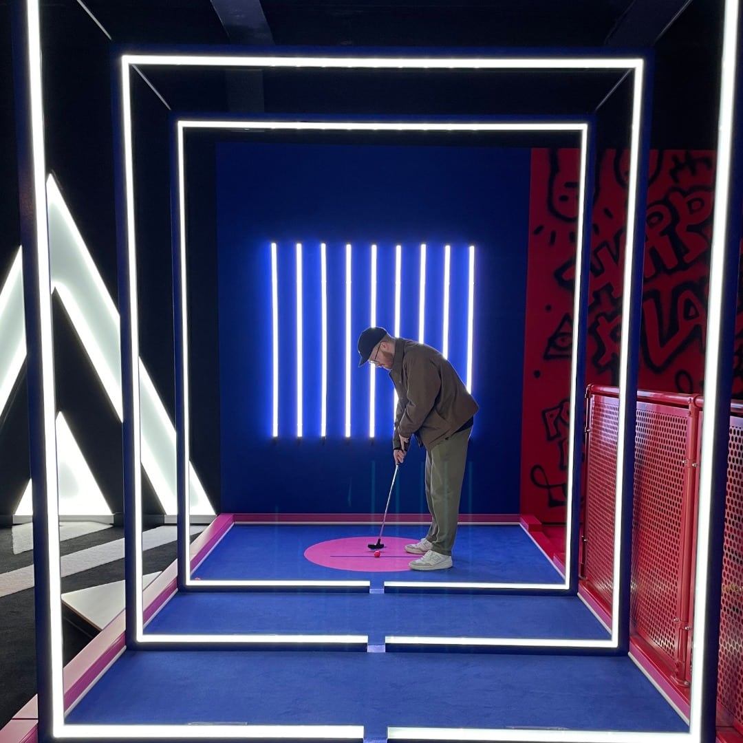 Interactive mini-golf setup in vibrant B-Side for corporate events and social gatherings.