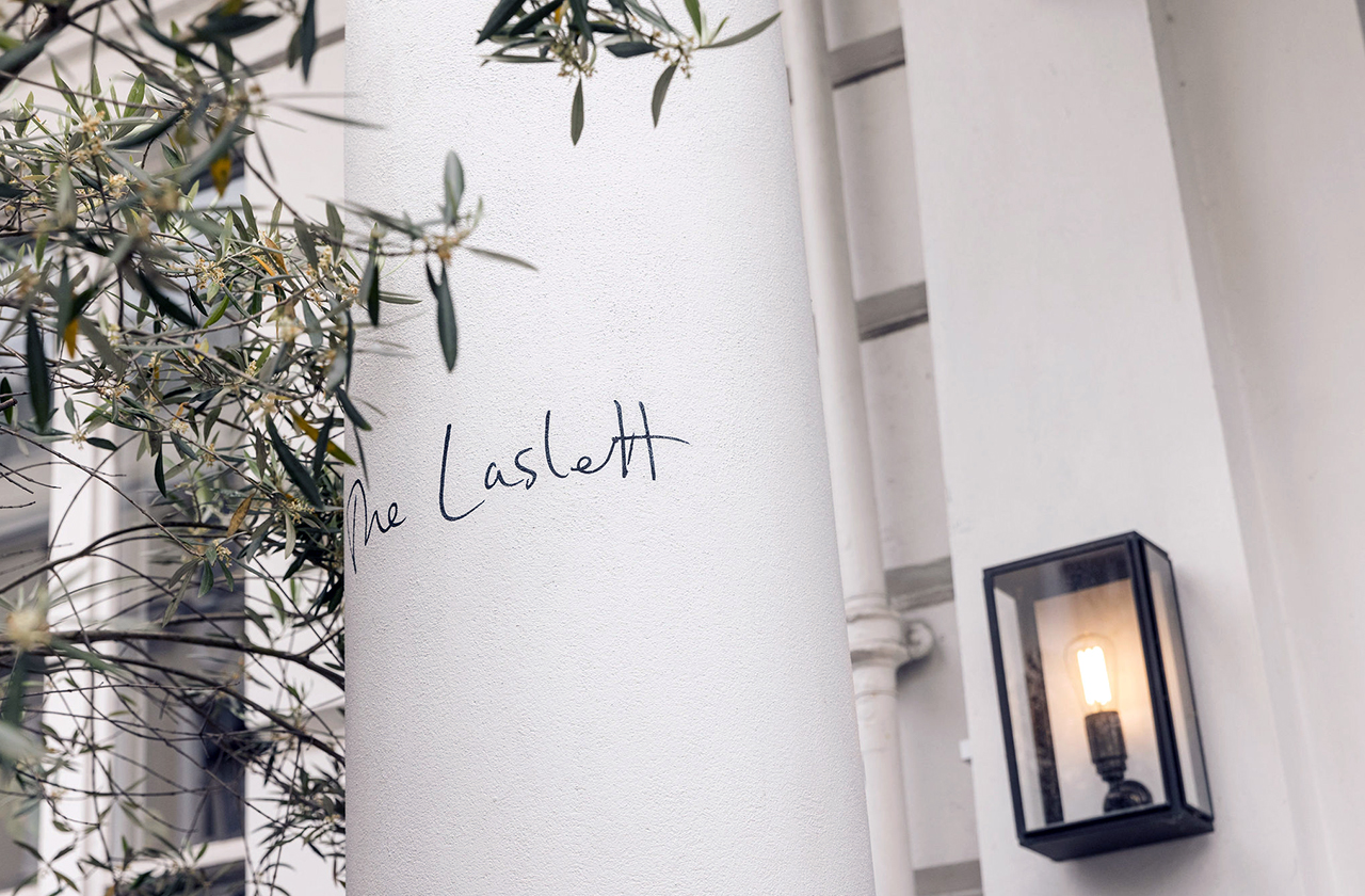 Stylish venue entrance at The Laslett with polished column, ideal for upscale events.