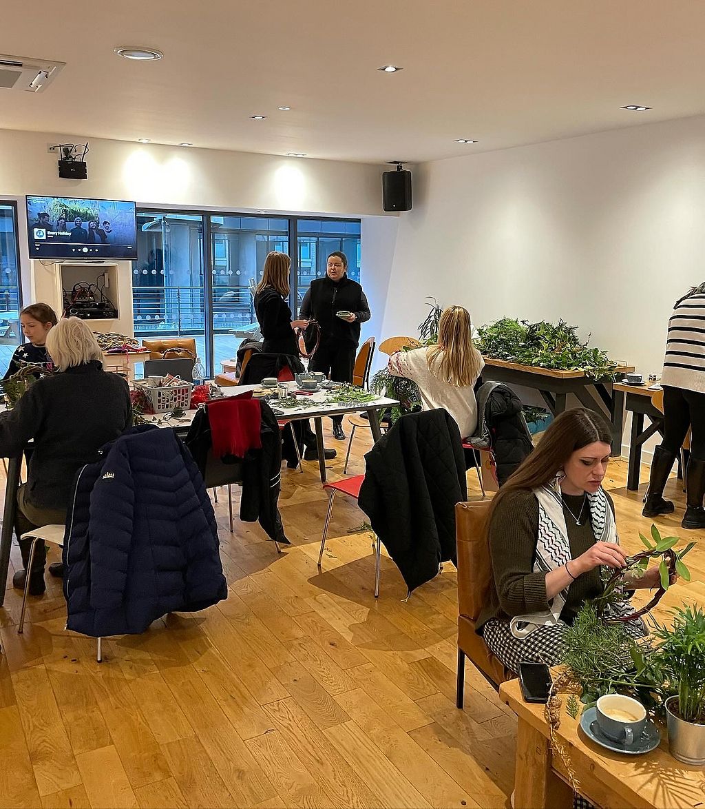 Workshop at Towpath Cafe with floral design, greenery, and interactive networking.