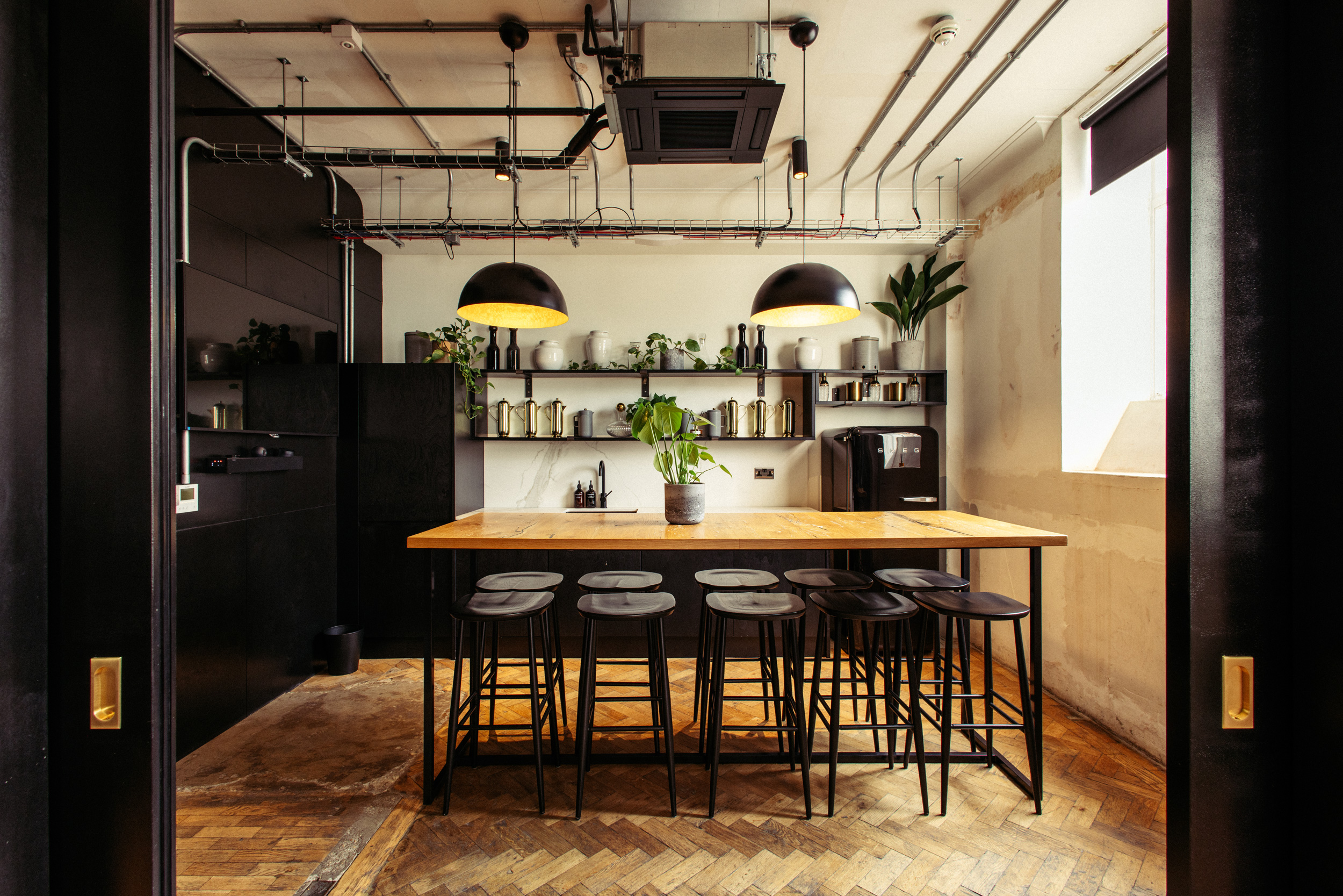 Modern kitchen space with wood accents for networking events and team-building activities.