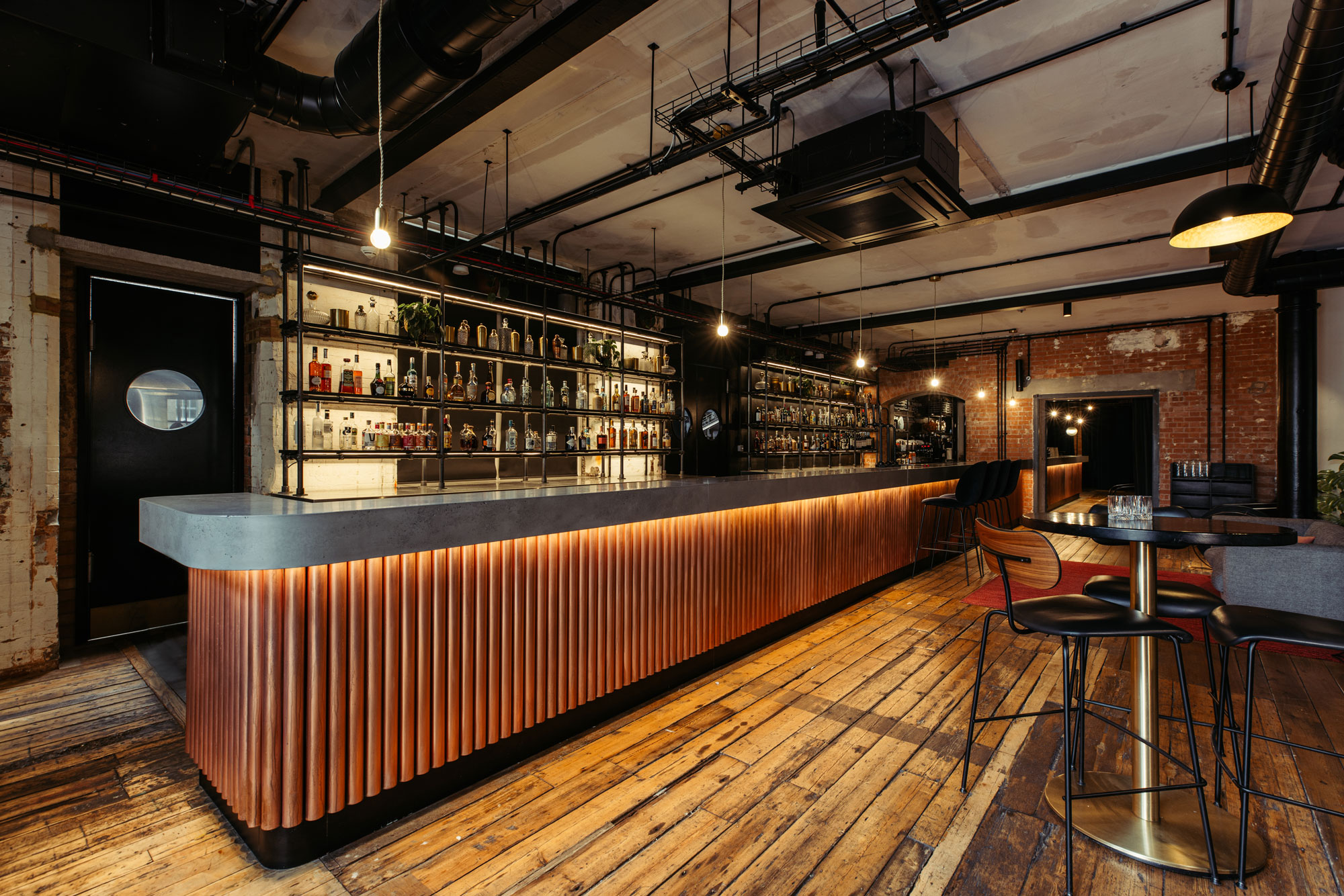 Stylish bar area with warm wood accents, ideal for cocktail receptions and networking events.