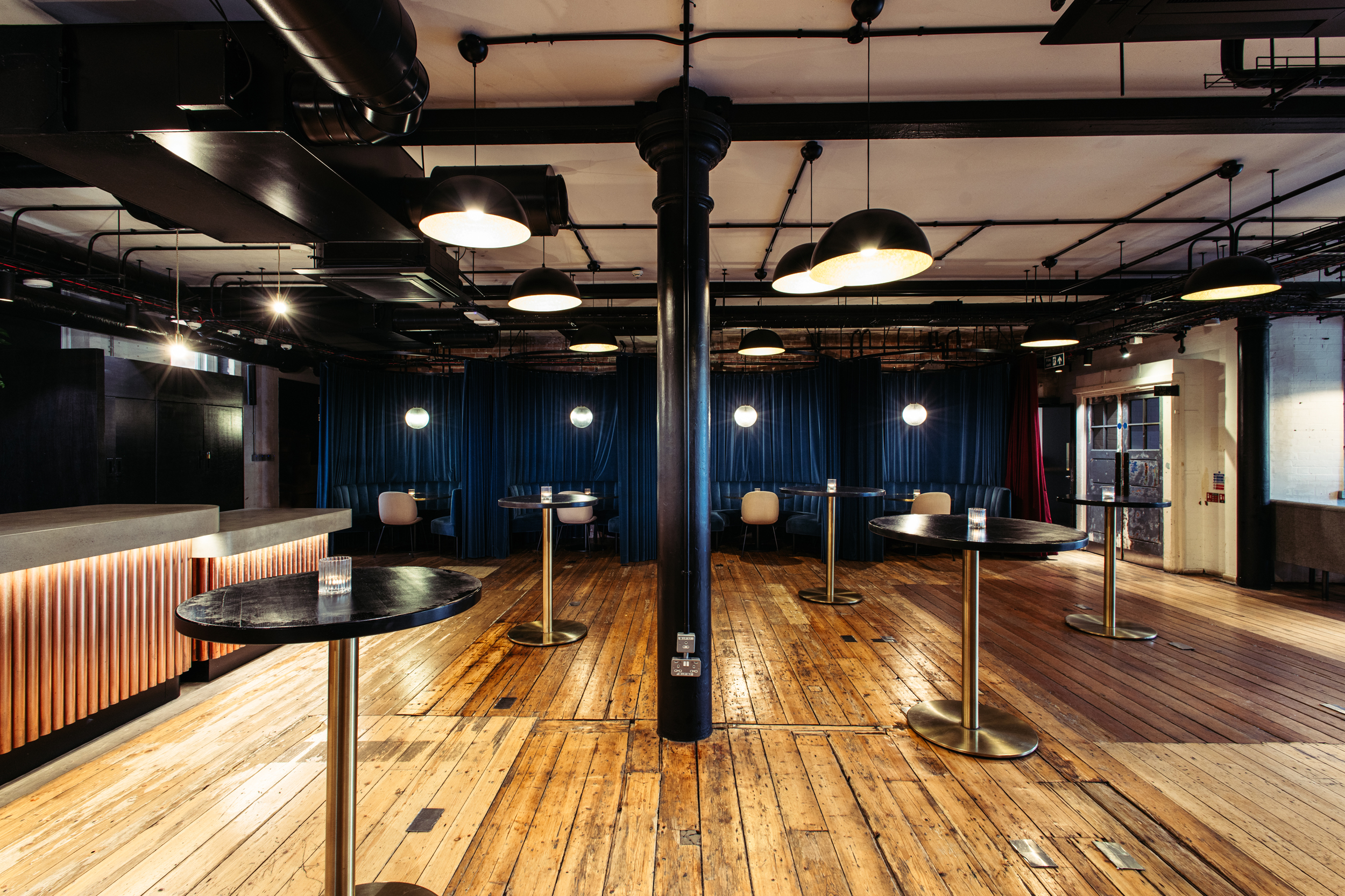 Versatile event space with polished floors, ideal for networking and cocktail receptions.