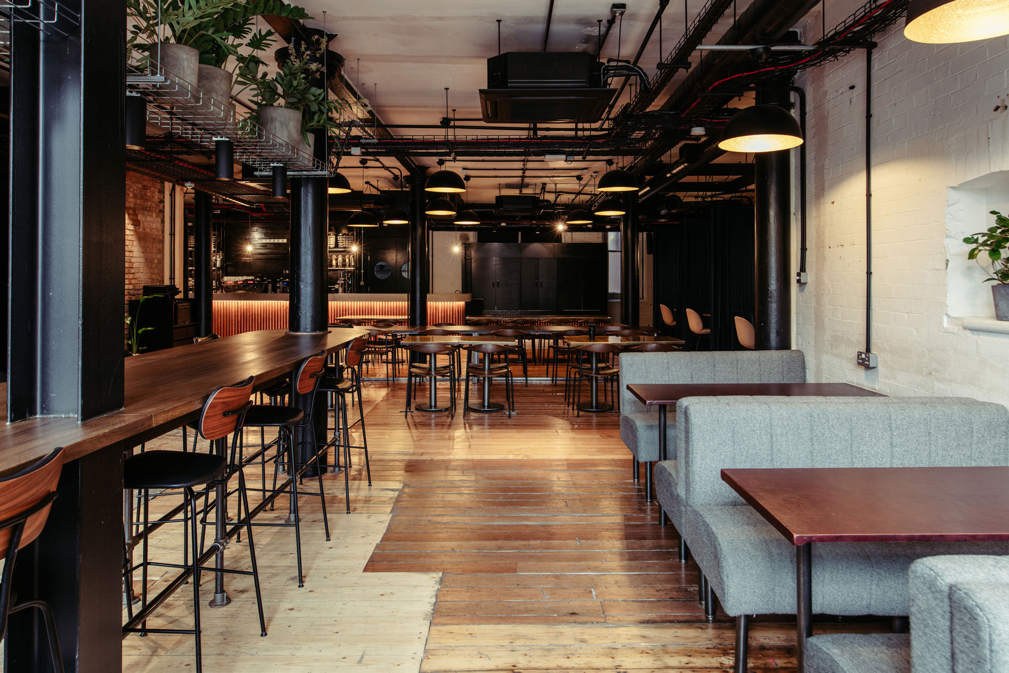 Modern industrial event space with flexible seating for networking and workshops.