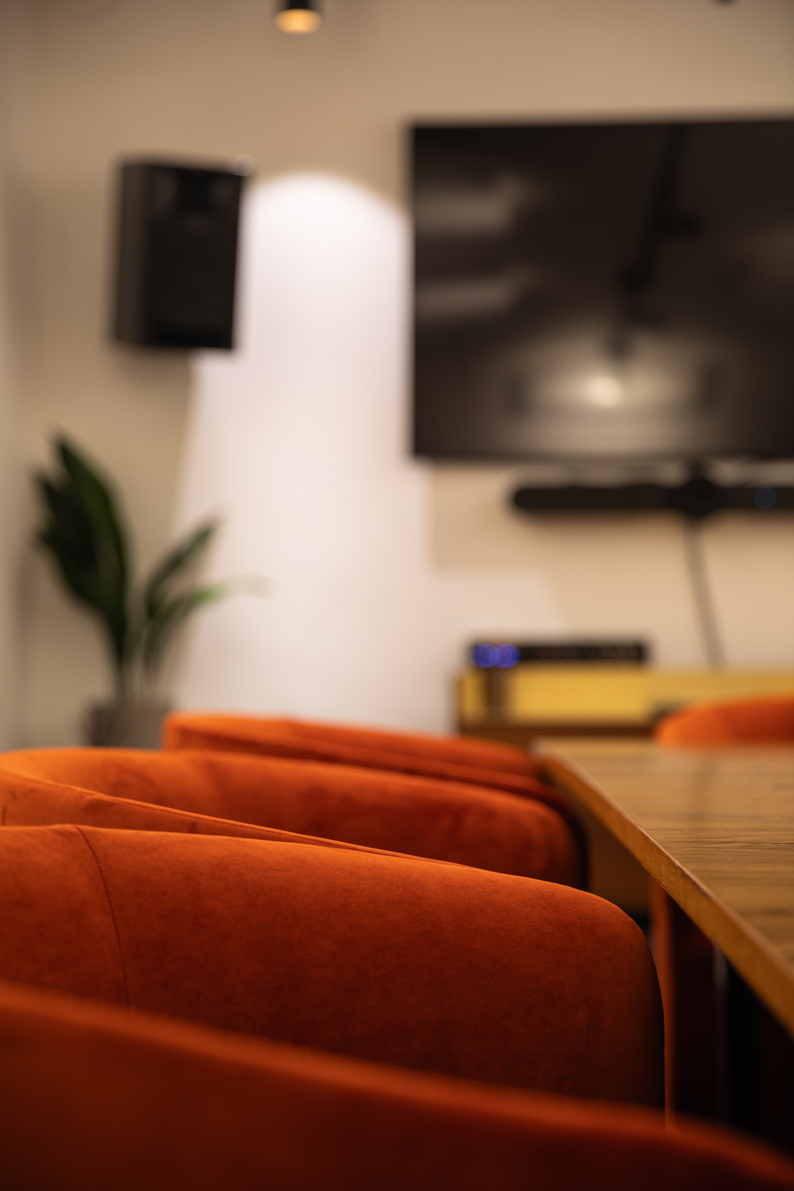 Modern meeting space with vibrant orange chairs, ideal for creative events and presentations.