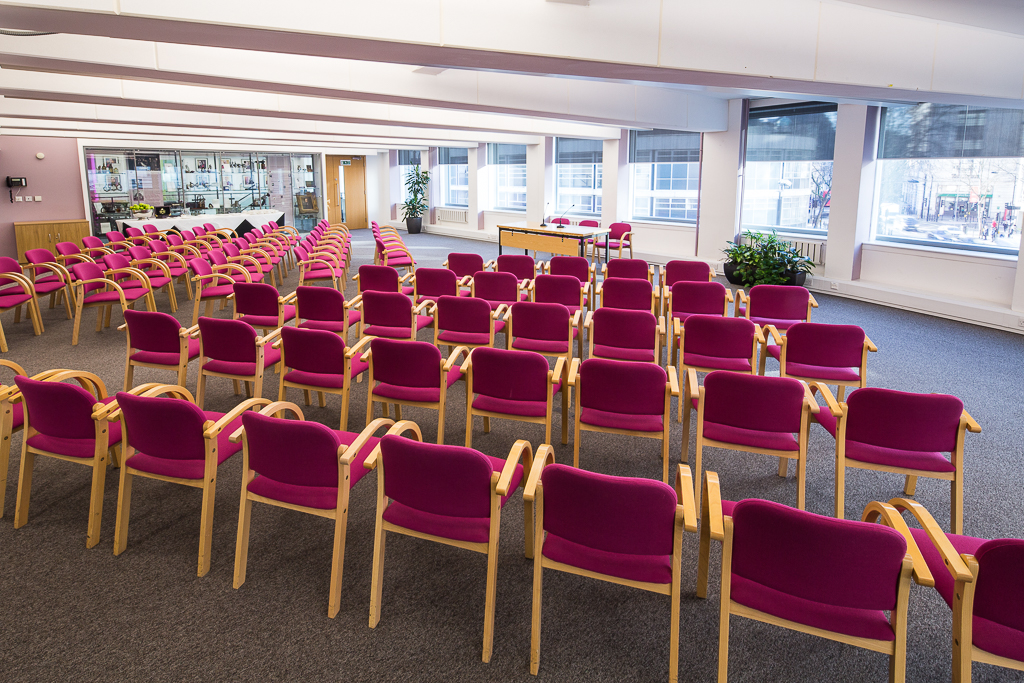 Gallery 1 in Churchill House with vibrant pink chairs for corporate workshops and training.