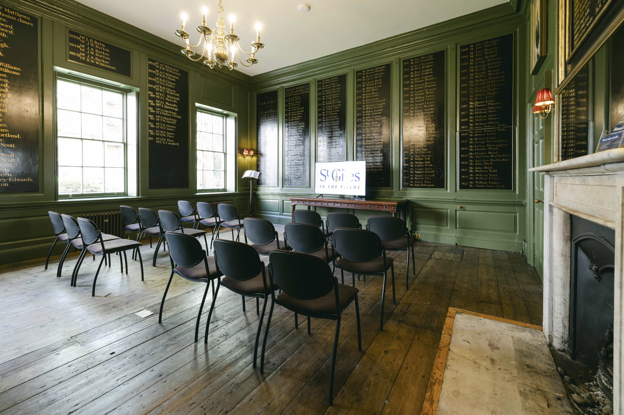 Vestry House meeting room with dark green walls, ideal for workshops and conferences.