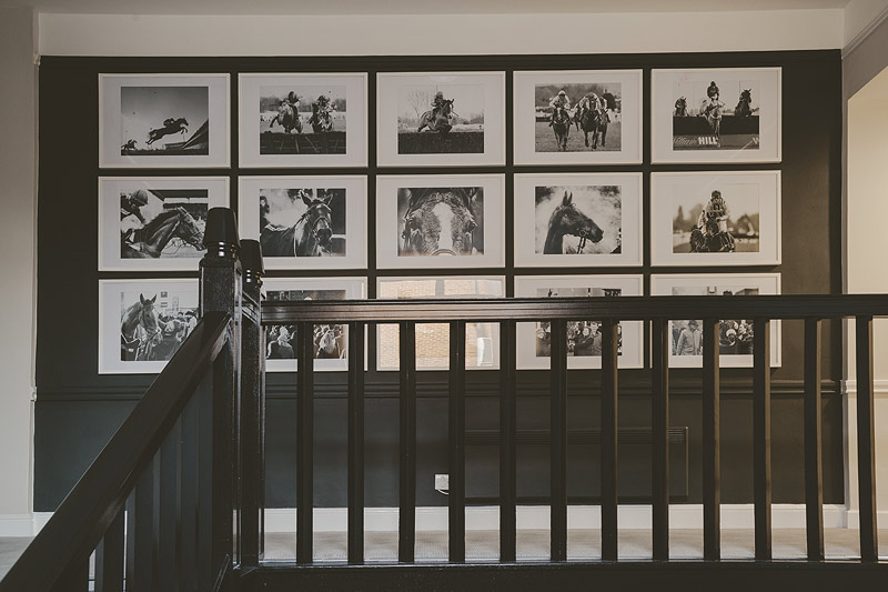 Royal Box at Kempton Park Racecourse with elegant black-and-white equestrian photos.