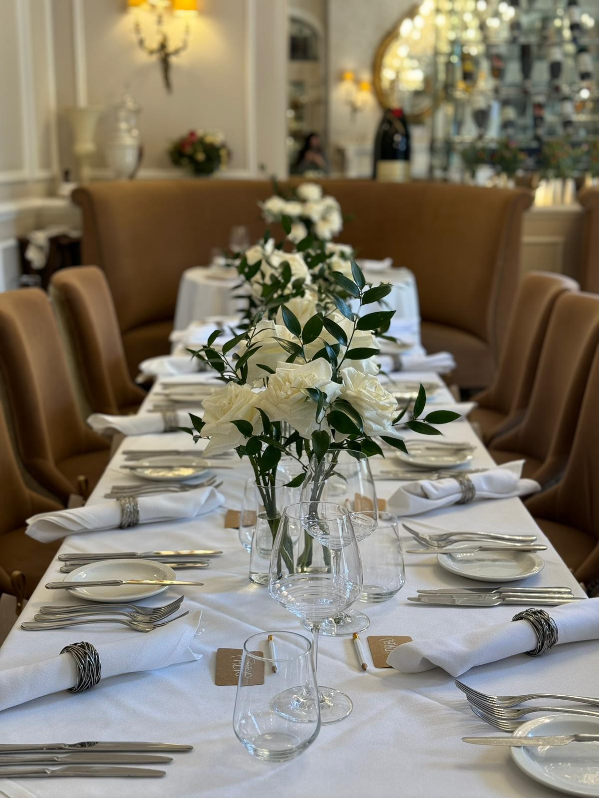Elegant dining table with floral centerpieces at The Churchill Room, St Paul's Hotel event space.