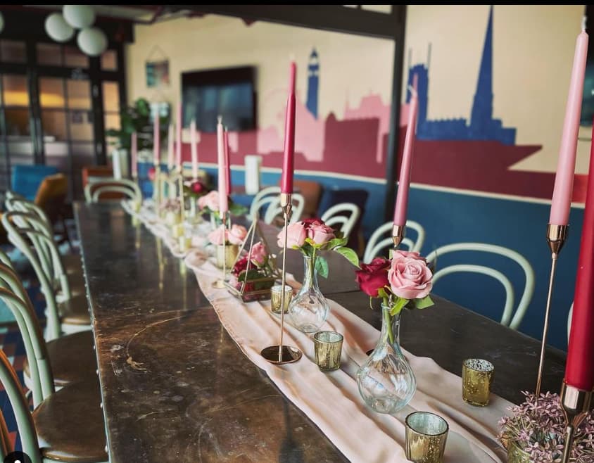 Elegant long table with pink candles for intimate gatherings at The Furnace.