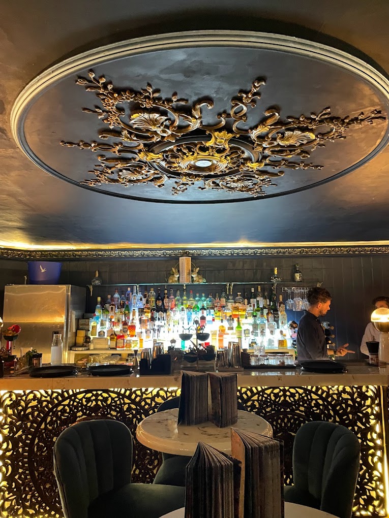 Stylish bar with ornate ceiling, ideal for networking events and celebrations.