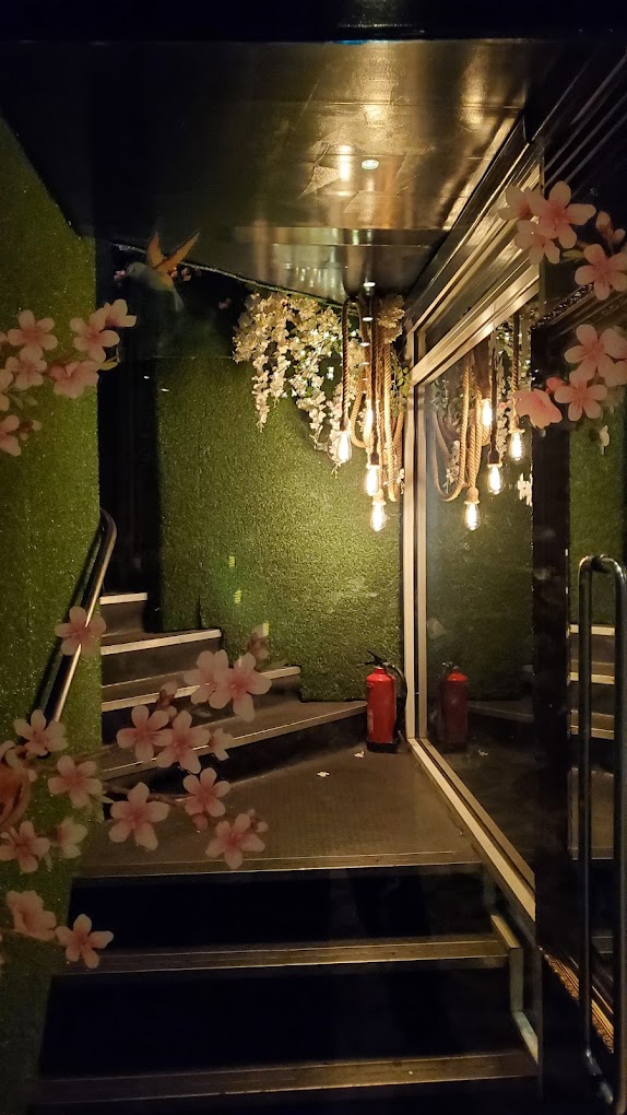 Stylish venue entrance with lush green walls for upscale events at The Rabbit's Hole.