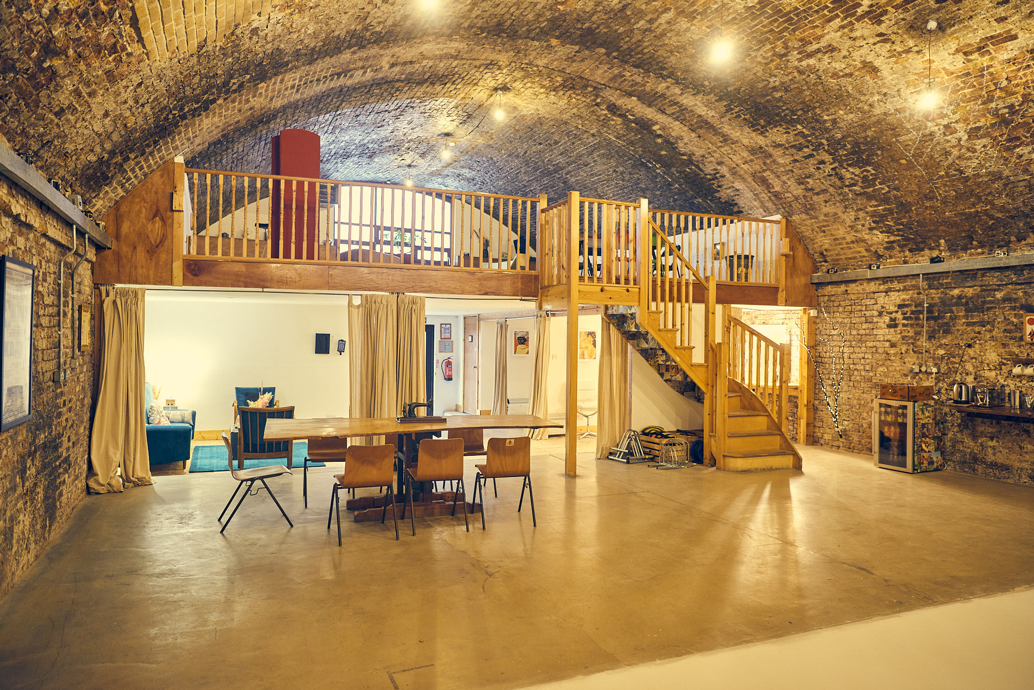 Rustic event space with exposed brick walls, ideal for corporate meetings and social events.