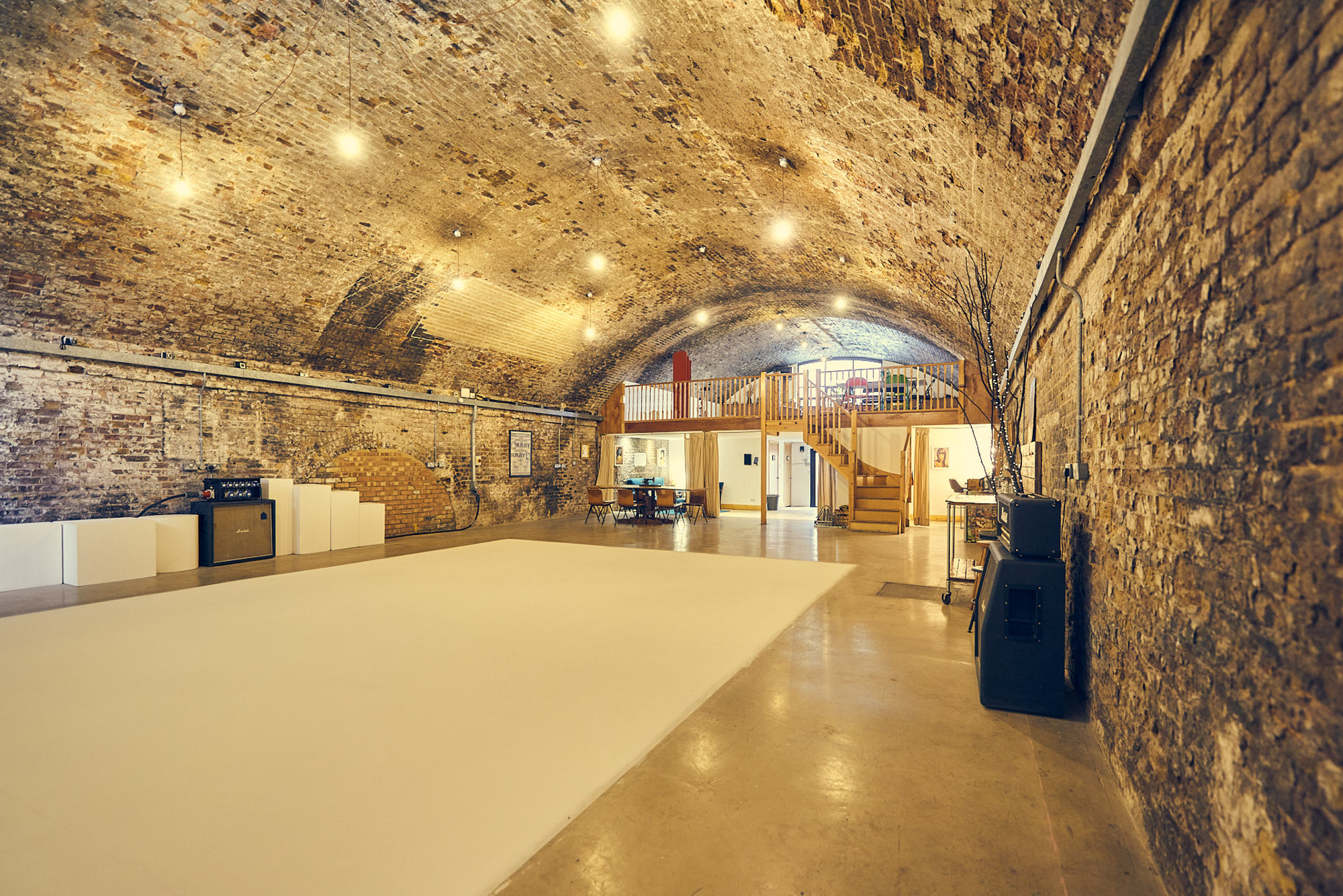 Versatile event space with exposed brick walls, ideal for corporate meetings and workshops.