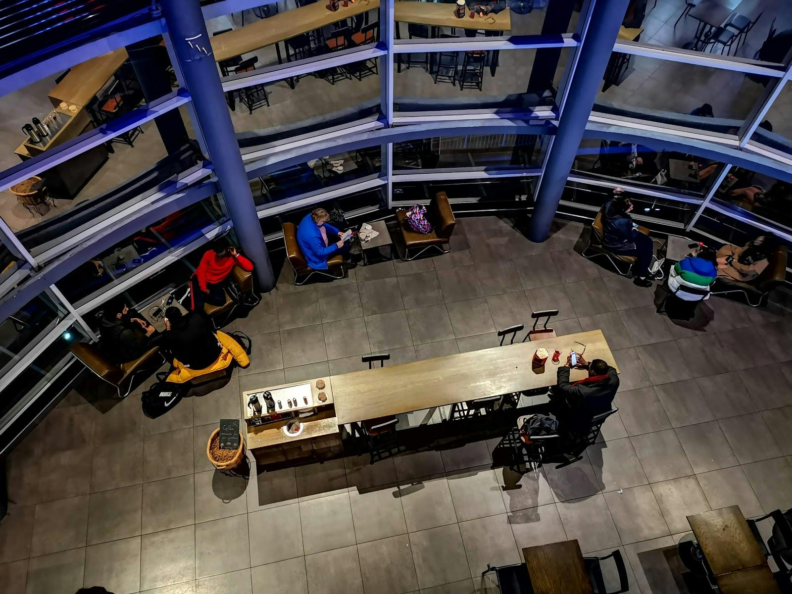 Modern café at Cineworld Enfield, ideal for networking events with communal seating.