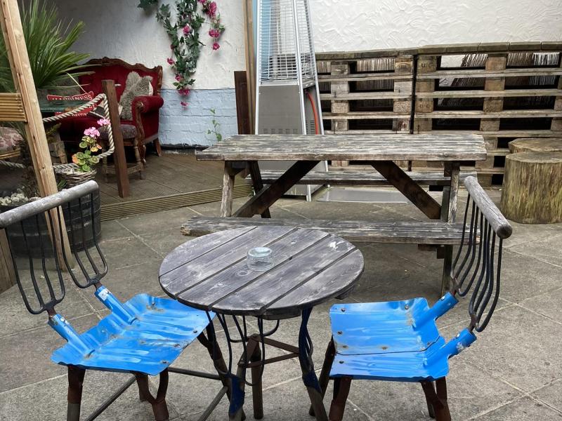 Cozy beer garden at Builders Arms with rustic furniture for casual gatherings.