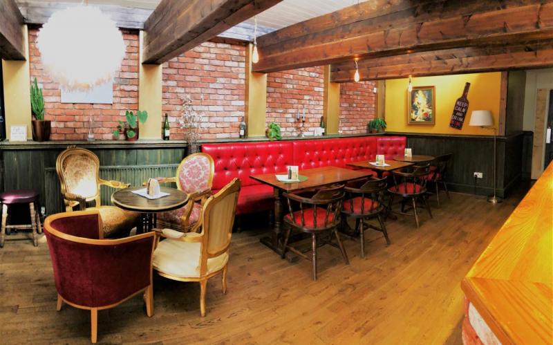 Cozy pub venue with plush seating for intimate meetings and casual events.