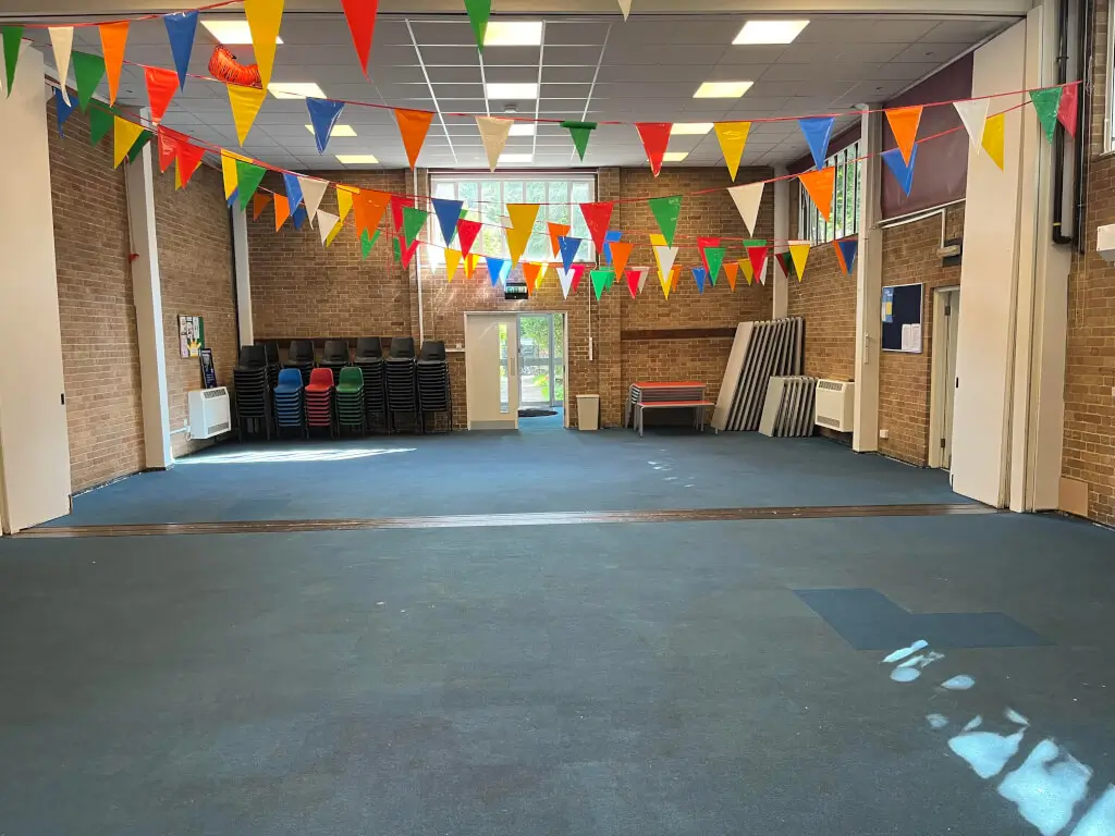 Versatile event space with colorful bunting for community gatherings and celebrations.