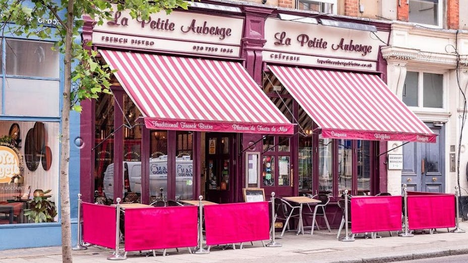 Charming French bistro with pink awnings, perfect for intimate gatherings and events.