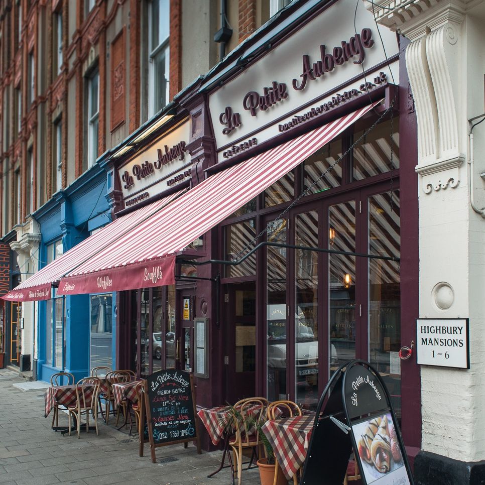 Charming La Petite Auberge venue with striped awning for intimate gatherings and events.