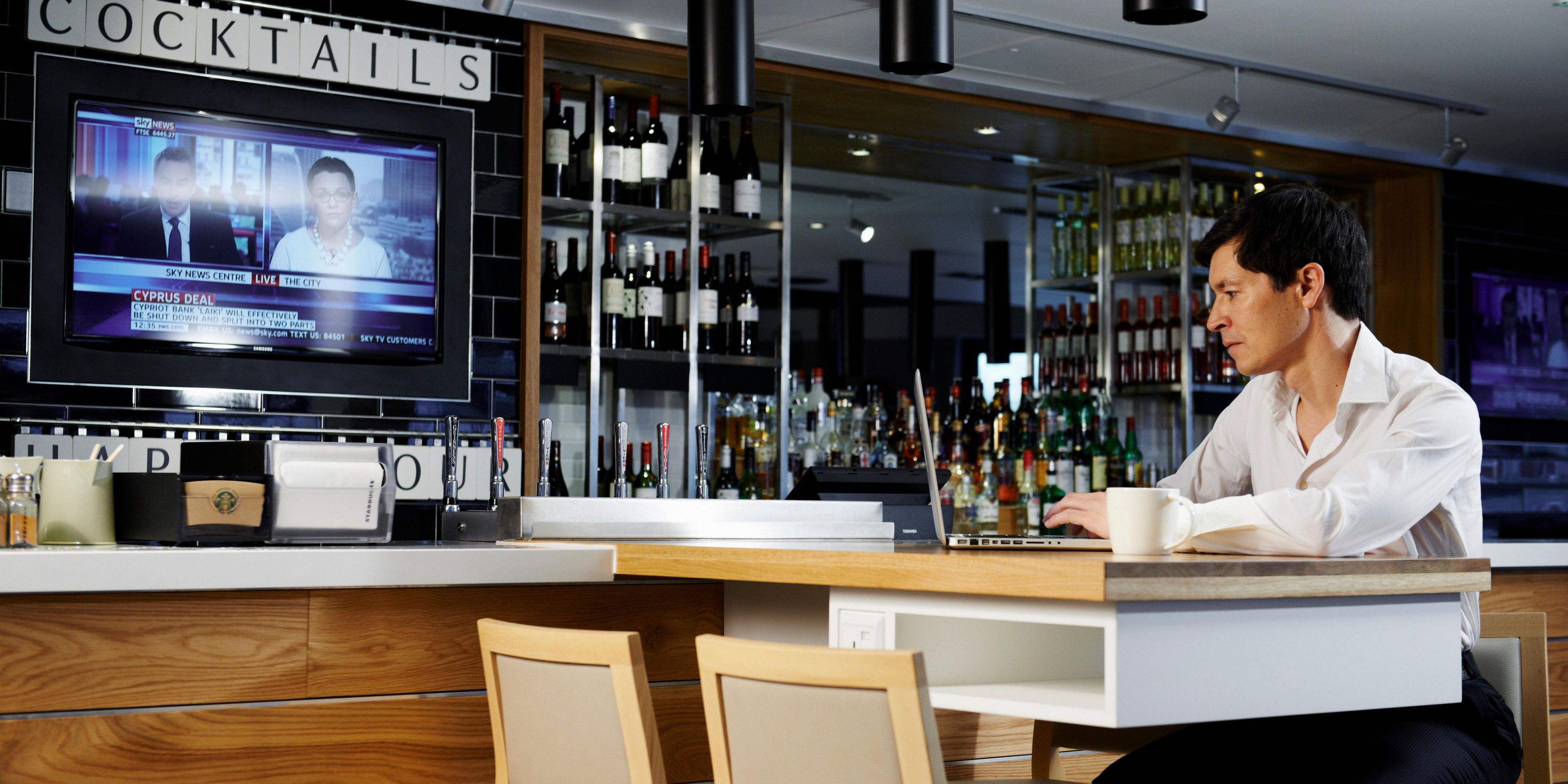 Meeting planner at sleek bar in Holiday Inn Brentford, ideal for events and networking.