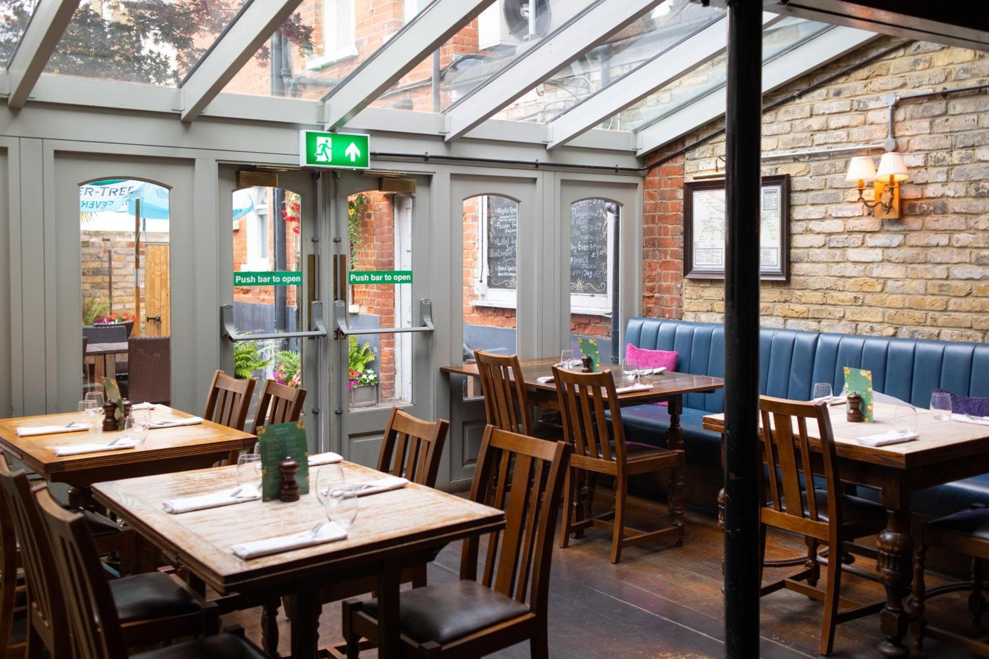 Charming Kew Gardens Hotel restaurant with glass roof, perfect for intimate dining events.