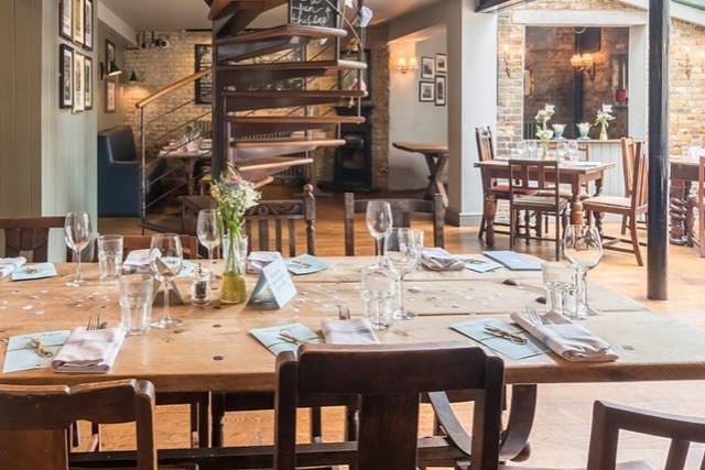 Charming Kew Gardens Hotel restaurant with rustic table, ideal for intimate gatherings and meetings.