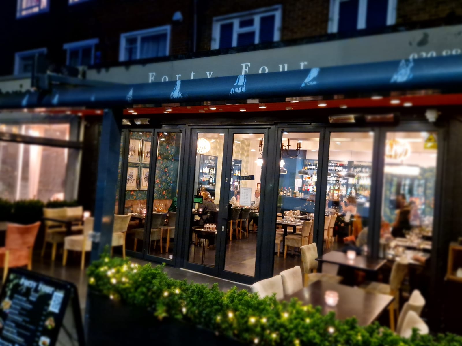 Charming restaurant exterior with outdoor seating, perfect for intimate gatherings and events.