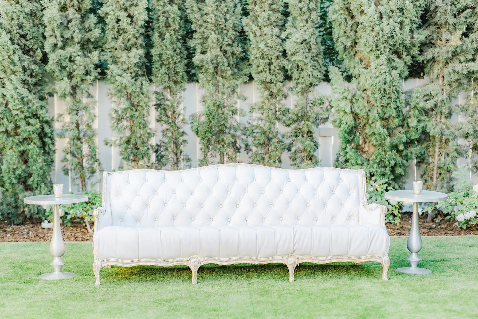 Elegant outdoor seating with vintage tufted sofa for networking events in San Diego.