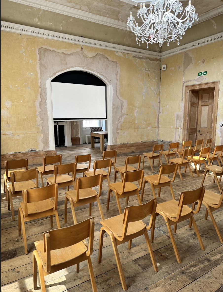Meeting space with wooden chairs for presentation in vintage Knotel Workclub venue.