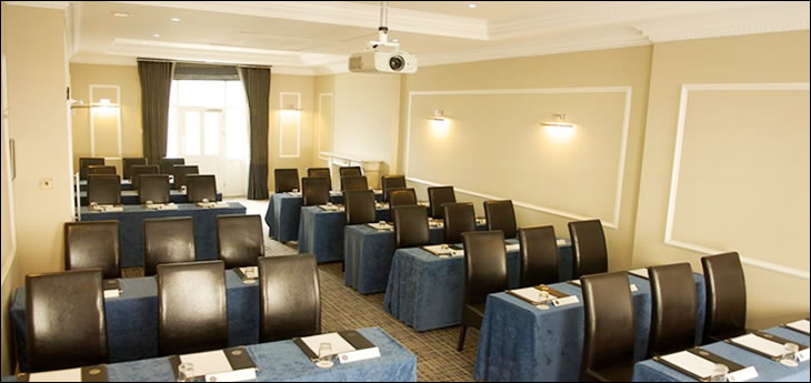 Meeting room at Grange Beauchamp Hotel with dark chairs, ideal for corporate events.