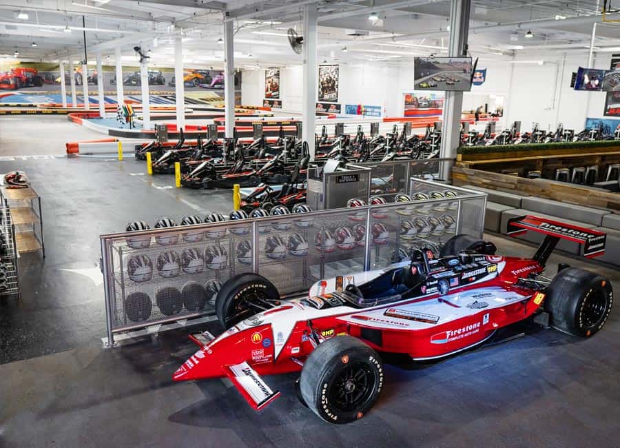 Paddock Lounge at K1 Speed Burbank, featuring a sleek race car for corporate events.