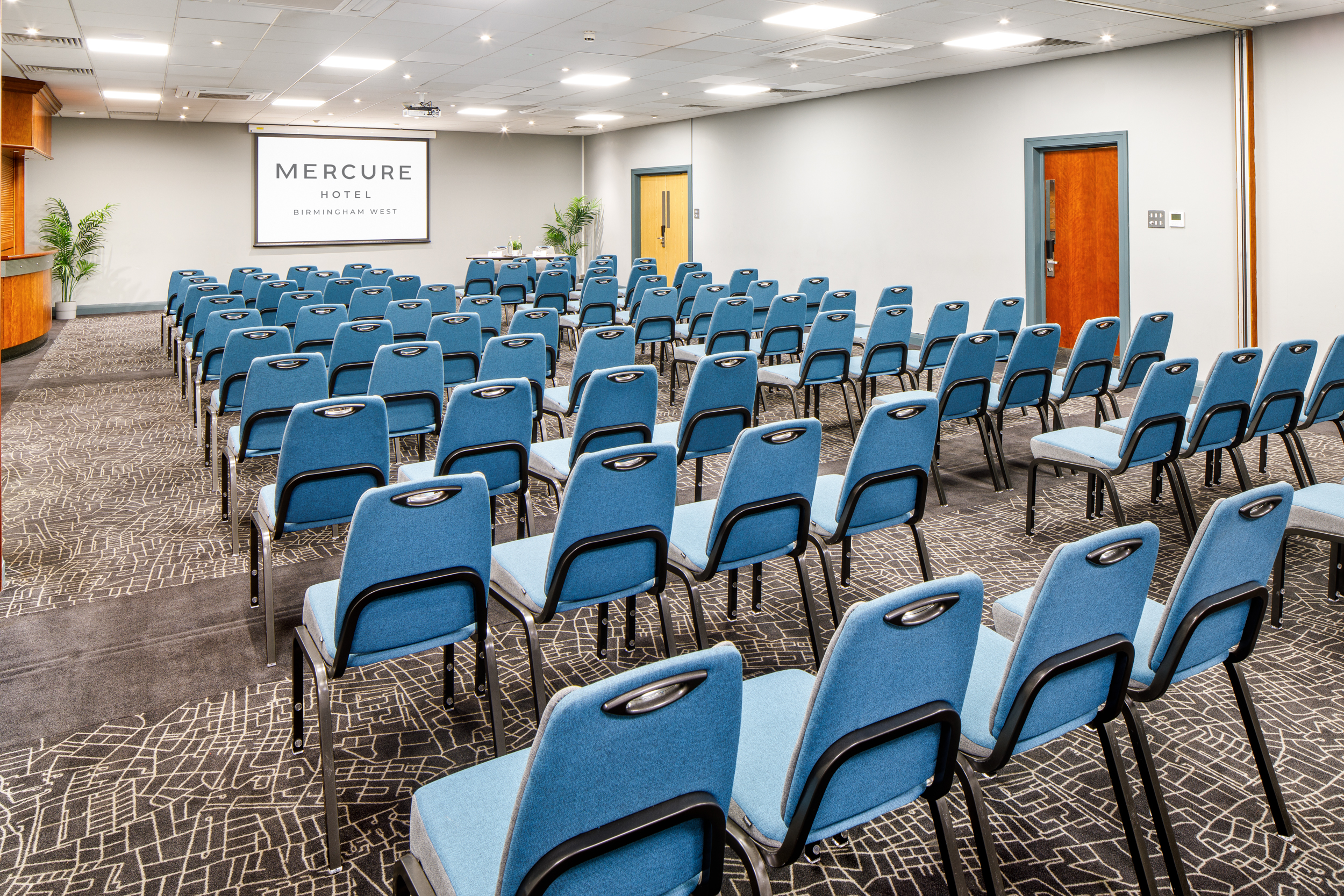 Hallard Suite meeting room with blue chairs, ideal for presentations and workshops.