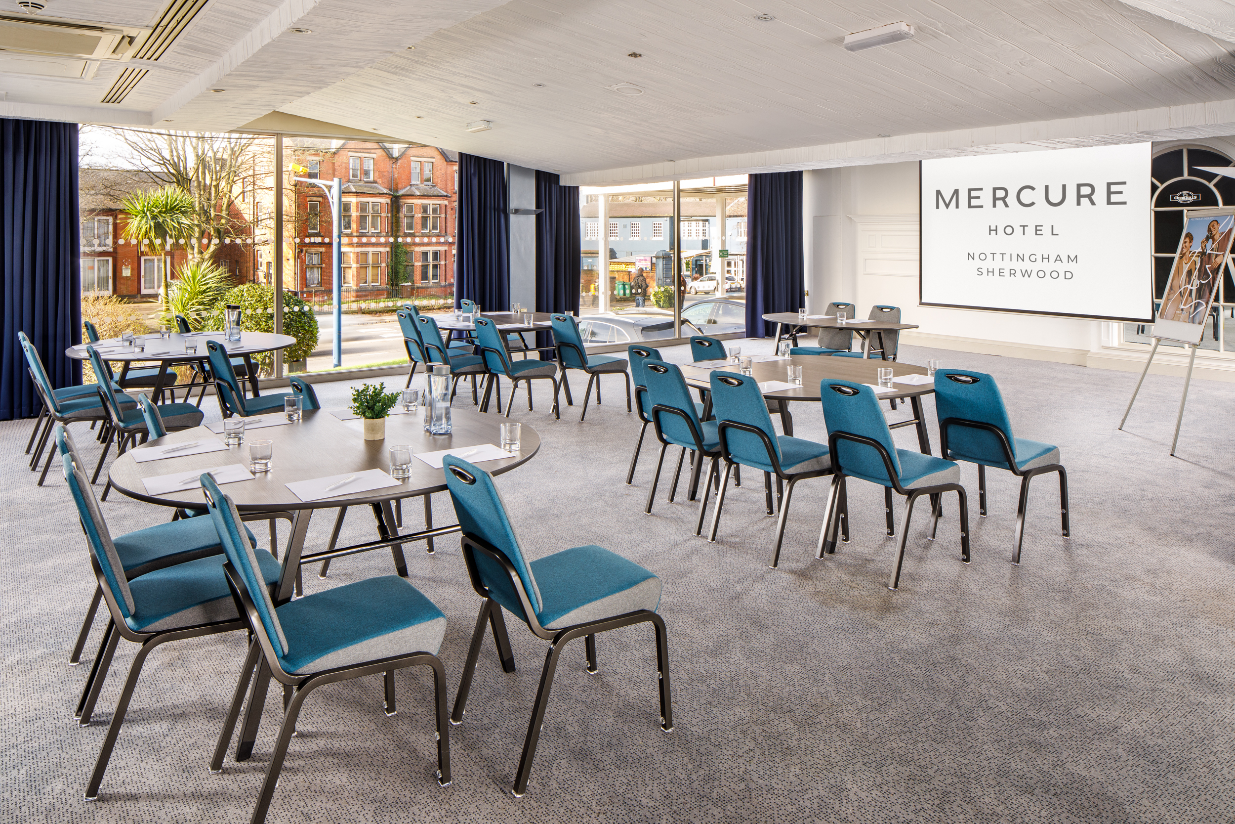 Churchills Suite at Mercure Nottingham: modern meeting room with blue chairs for corporate events.