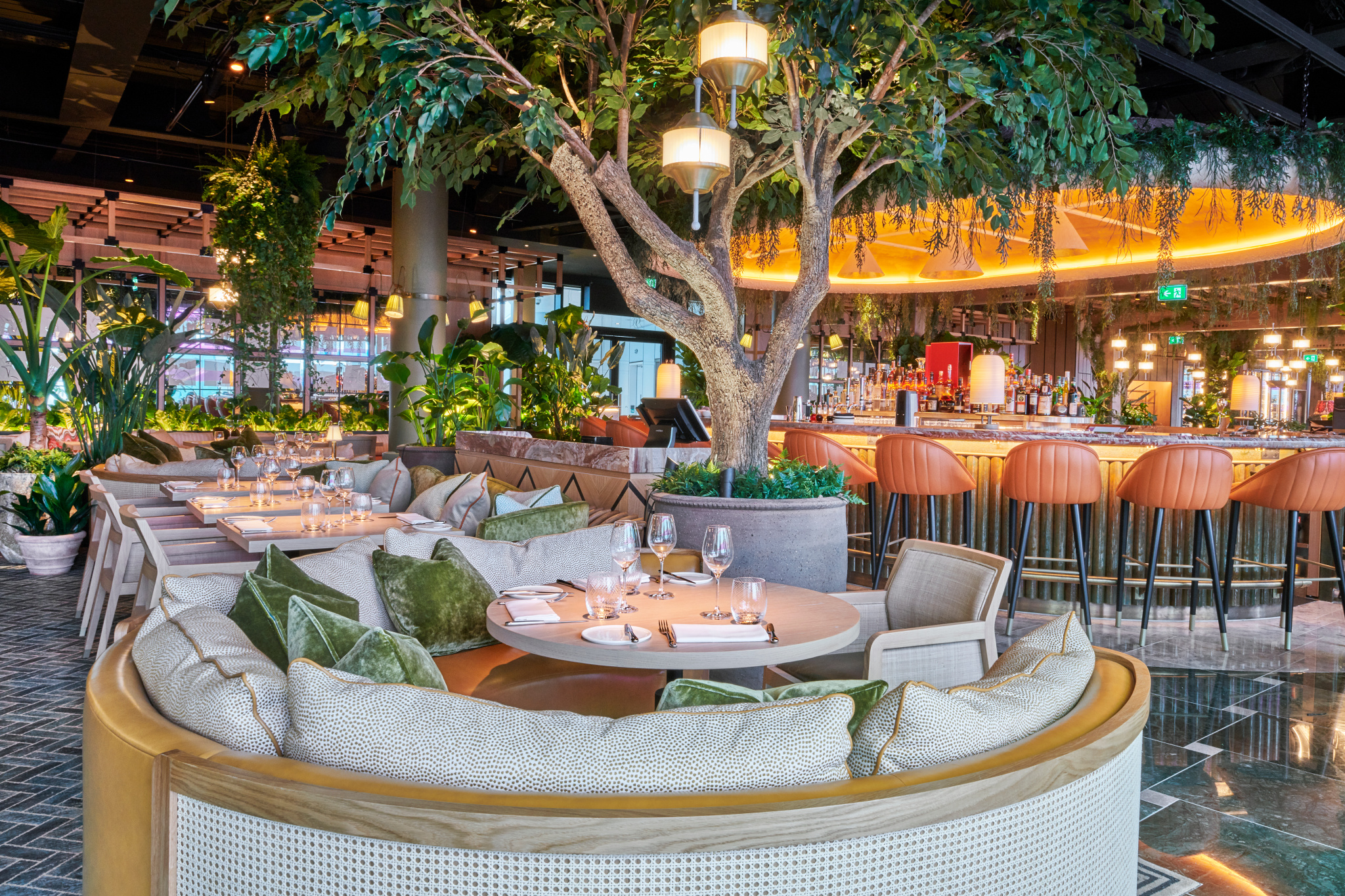 Semi-private lounge at 14 Hills with lush greenery for intimate gatherings and events.