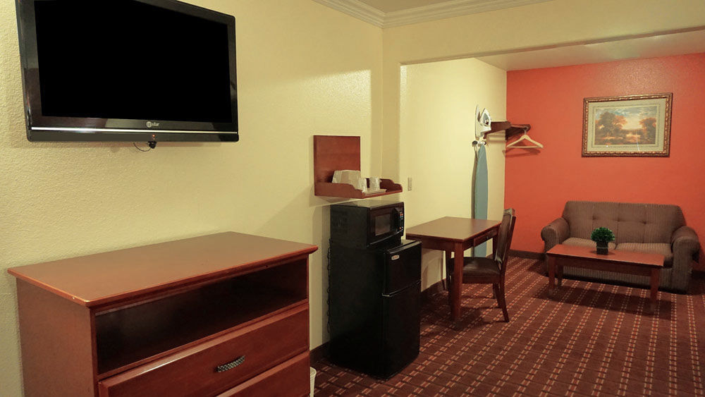 Compact hotel room at Regency Inn & Suites for small meetings and events.